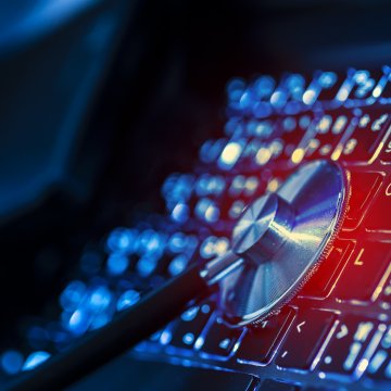 Advanced System Repair registry cleaner utility software stethoscope on black illuminated computer keyboard